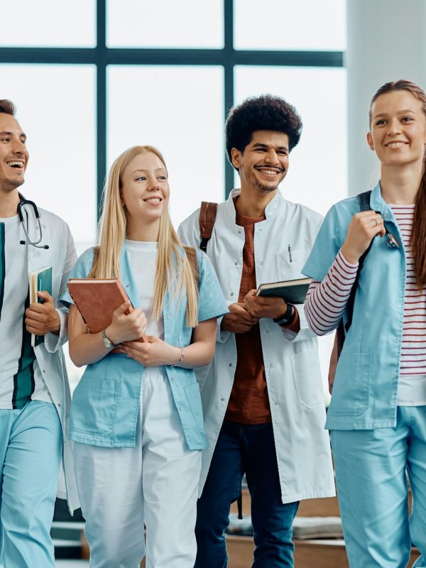 Happy medical and nursing students leaving the amphitheater after a lecture at medical university.